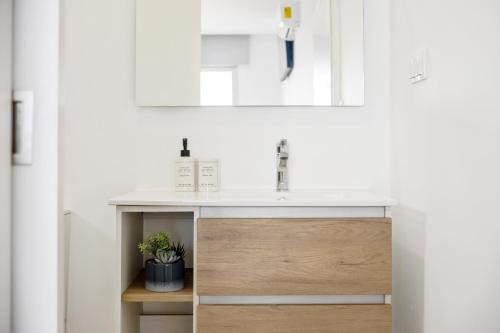a bathroom with a sink and a mirror at Villa Vellure by Homie in Funchal