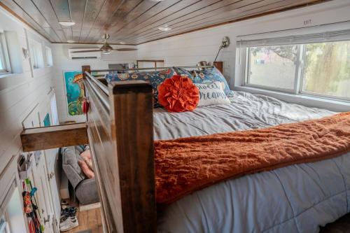 a bed in a tiny house with a large window at Tiny Home w Great Bay Views Pets Near Eglin Beach in Freeport