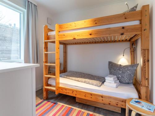 a bunk bed in a small room with a window at Ferienwohnung für 4 in Vollerwiek in Vollerwiek