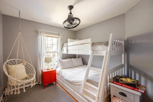 a bedroom with two bunk beds and a swing at Waterfront Home Just Minutes To Beach in Naples