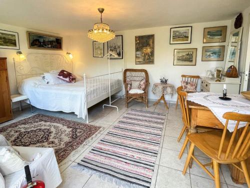 a bedroom with a bed and a table and chairs at 2 person holiday home in BORRBY in Borrby