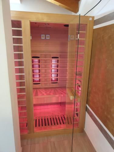 a room with pink walls and a glass door at Vacation house "Viola" in Fažana