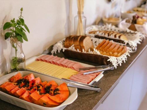 a buffet with cheese and fruit on a table at Parador Casa da Praia in Torres