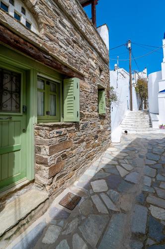 a stone building with a green door and a stone sidewalk at Sea view house , for 5 persons in Triandaros in Triandáros