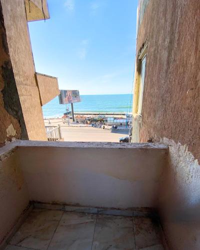 a view of the beach from a window of a building at Alex Rooms in Alexandria