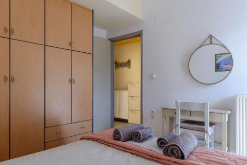 a bedroom with a bed with a mirror and a desk at AGALI 2 Superior Mezonet front of the sea in Akrogiali