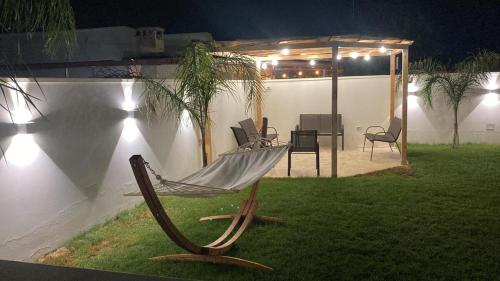 a hammock chair in a yard at night at Villa Madame in Monacizzo