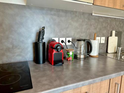 - un comptoir de cuisine avec un appareil rouge dans l'établissement Appartement, cosy le Bouscat, à Le Bouscat