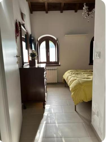 a bedroom with a bed and a window at At Nonna Maria's house in Casenove