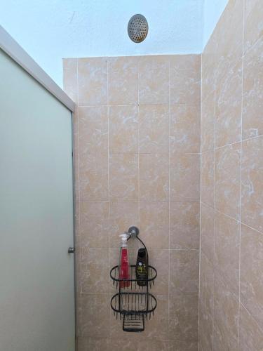 a shower with a soap dispenser in a shower stall at Tu espacio ideal in San Miguel
