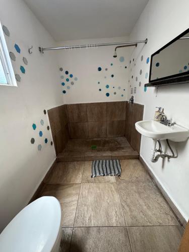 a bathroom with a toilet and a sink at Casa Cristal in Mexico City