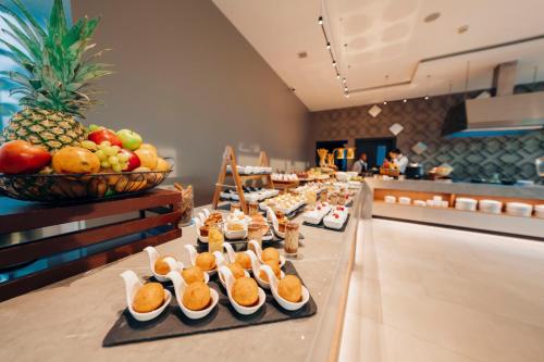 a buffet line with appetizers and fruit on a table at Wyndham Quito Airport in Tababela