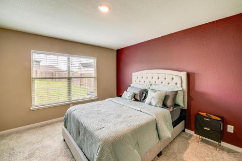 a bedroom with a large bed with a red wall at Patio and Fenced Yard Peaceful Venus Retreat in Midlothian