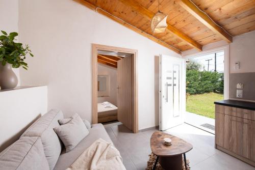 a living room with a couch and a table at Kentrikon Rooms III & Mint House in Limenaria