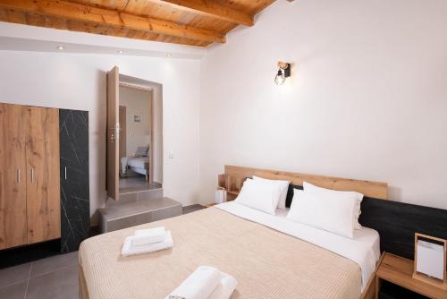 a bedroom with a large bed with two white pillows at Kentrikon Rooms III & Mint House in Limenaria
