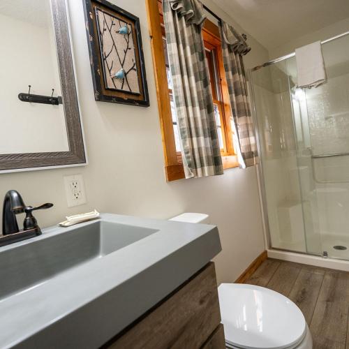 a bathroom with a sink and a toilet and a shower at Aspen - by The Chalets in Logan