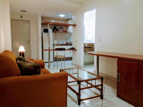 a living room with a couch and a table at Flat Via Park wi fi liberado in Campos dos Goytacazes