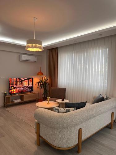 a living room with a couch and a table at Cozy Atmosphere in the Heart of Town in Dalaman