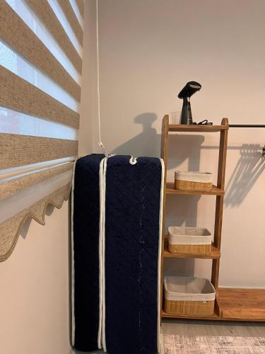 a suitcase hanging from a wall next to a shelf at Cozy Atmosphere in the Heart of Town in Dalaman