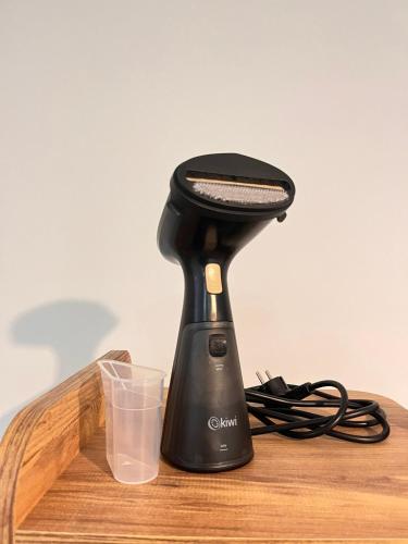 a black blender sitting on top of a wooden table at Cozy Atmosphere in the Heart of Town in Dalaman