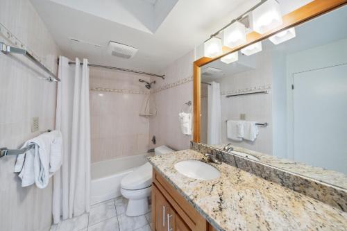 a bathroom with a sink and a toilet at Oceanview 30th Floor Condo Just Steps from Waikiki Beach, Full Kitchen, Free Parking (13007) in Honolulu