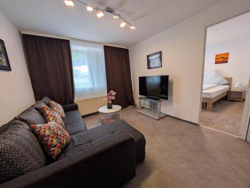 a living room with a couch and a television at Apartment in Kordel in Kordel