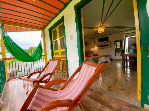 a room with chairs and a balcony at Mamatina Hotel in Santa Rosa de Cabal