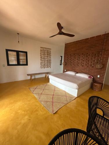a bedroom with a bed and a ceiling fan at Cabañas Mizontle in Mazunte