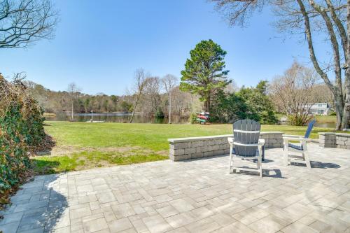 two chairs sitting on a patio in a park at Patio and Pond View Serene Cape Cod Escape in Mashpee