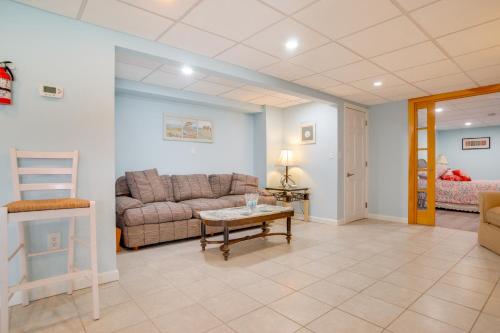 a living room with a couch and a table at Patio and Pond View Serene Cape Cod Escape in Mashpee