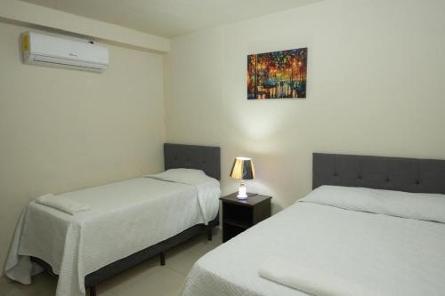 Postel nebo postele na pokoji v ubytování Hotel Centenario