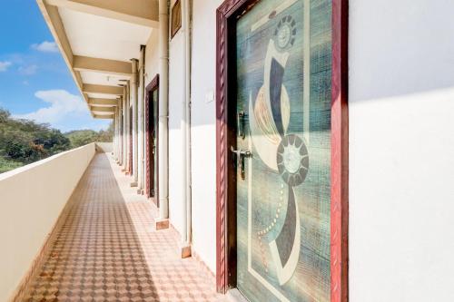 an empty corridor of a building with a mural on the door at Hotel O Star Inn in Hyderabad