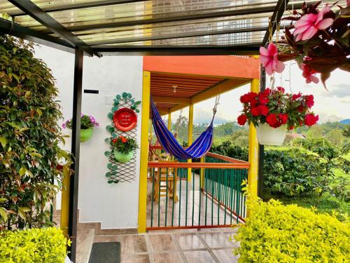 a porch with a hammock on a house at Mamatina Hotel in Santa Rosa de Cabal