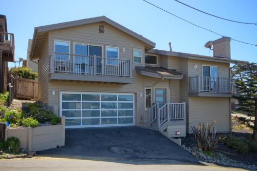 a house with a large garage in front of it at Cambria Park Shores in Cambria