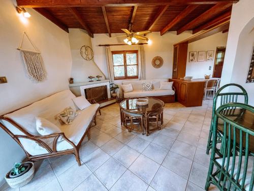 a living room with a couch and a table at Mantis Home in Syvota