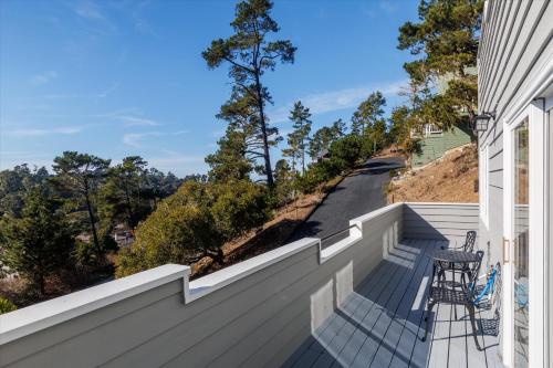 a balcony with a table and chairs on a house at Van Gogh Villa in Cambria