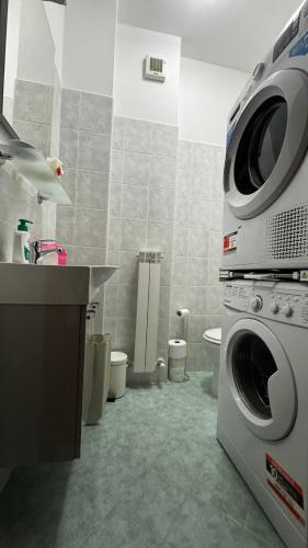 a bathroom with a washer and dryer in it at Casa SUN in Civitanova Marche