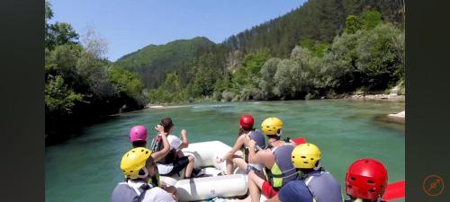 a group of people on a raft on a river at Apartment Horizontes Azules in Konjic