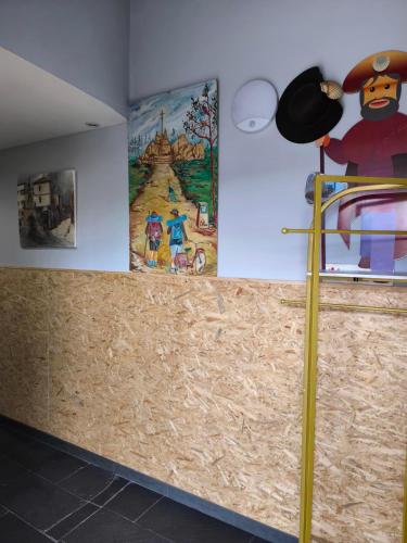 a room with paintings on the wall and a counter at Albergue con encanto d'camiño in Padrón