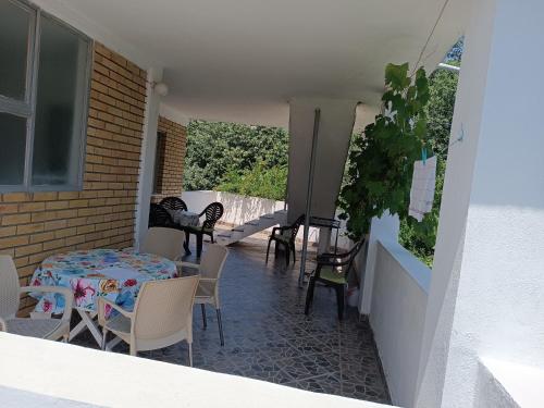 a patio with a table and chairs on a balcony at Apartments M1 Pine tree in Sutomore