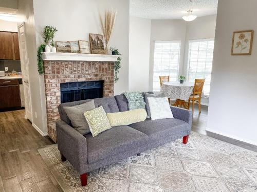 a living room with a couch and a fireplace at Cozy and Quiet, with Easy Access & Private Garage in Corpus Christi