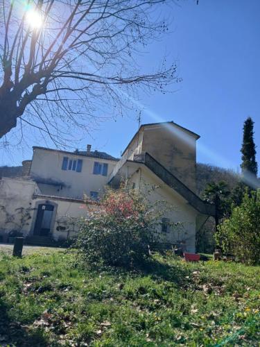 a house on a hill with the sun behind it at Dolce Vita in Saint-Laurent-le-Minier