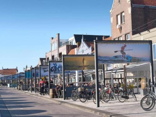 a row of signs on a city street with bikes at Apartment in Groede near the Beach in Groede