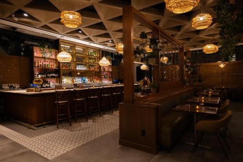 a bar with a row of bar stools at Godfrey Hotel Chicago in Chicago