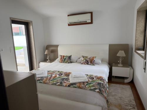a bedroom with a white bed and a window at casa Pinto Douro country in Ancede