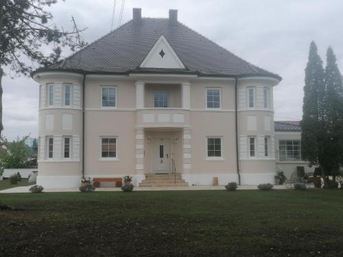 a large white house with a front door at Villa Romantika in Ichenhausen