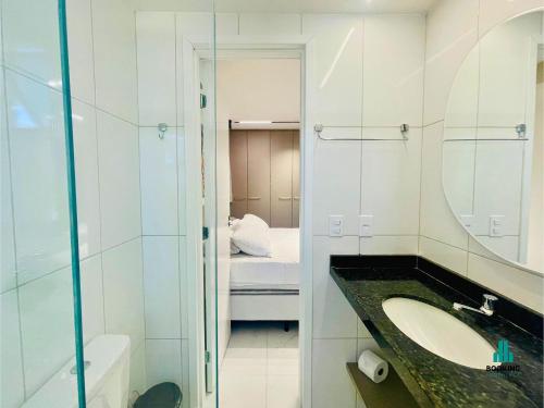 a bathroom with a sink and a mirror and a bed at Aquarius Style by Holiday Stays in Fortaleza