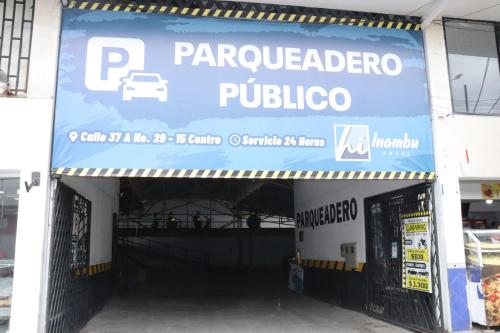 a parking garage with a sign for a car dealership at Hotel Inambu Villavicencio in Villavicencio