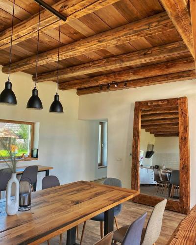 a dining room with a wooden table and chairs at Scrind 11 - Madleine Chalet in Cluj-Napoca