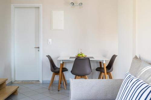 a dining room with a table and chairs at Blue View Villas in Stalida